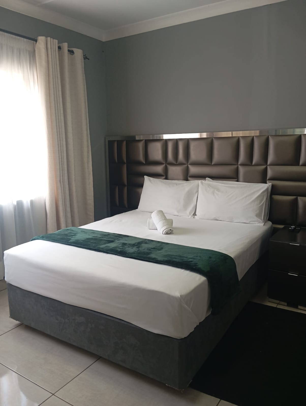 Lodge@36 room with padded headboard and queen bed